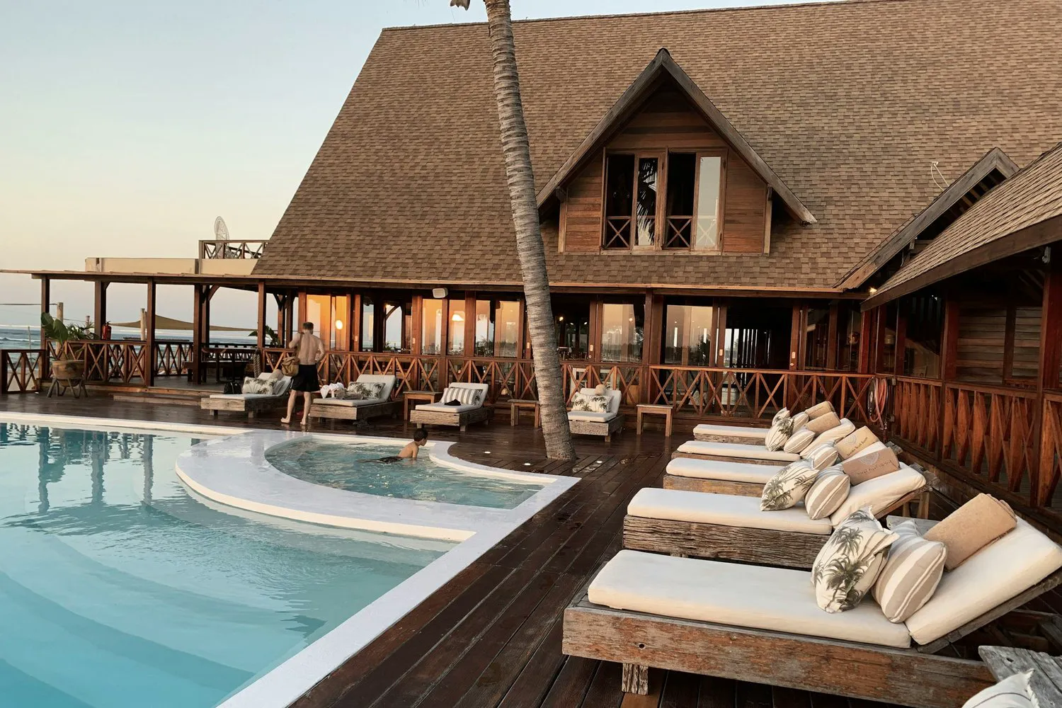 Tropical resort with poolside loungers